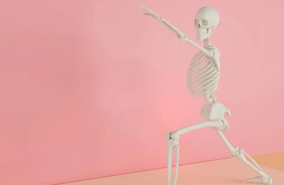 a skeleton holding a tennis racquet on a pink background